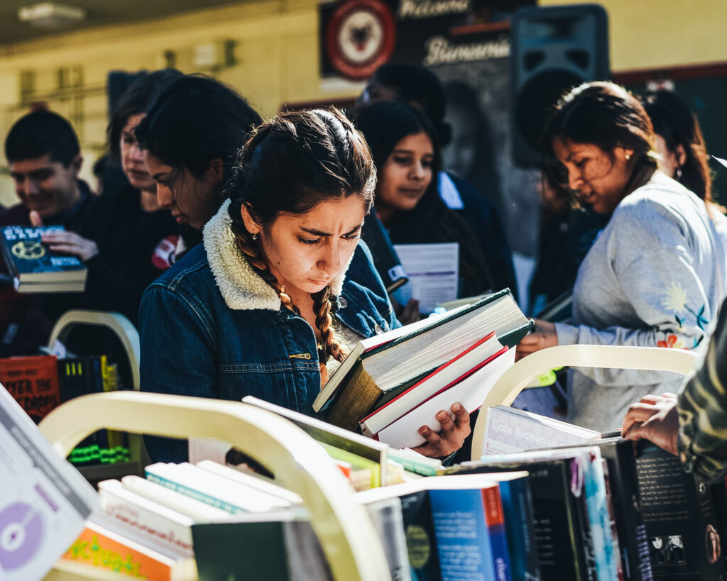 A young student sits and reads a textbook.