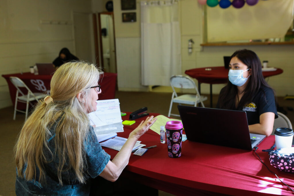 Client and tax prep volunteer speak at a shared table