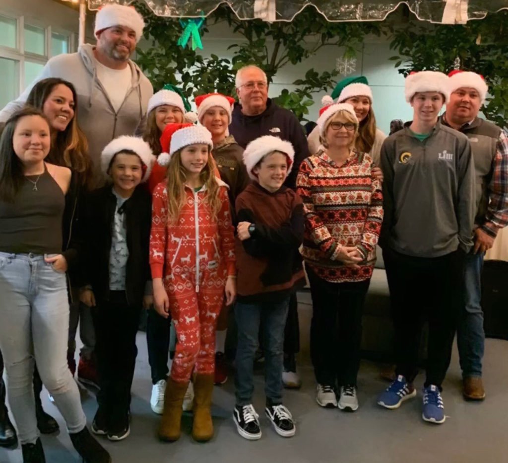 Andrew Whitworth and a group of people wearing Santa hats