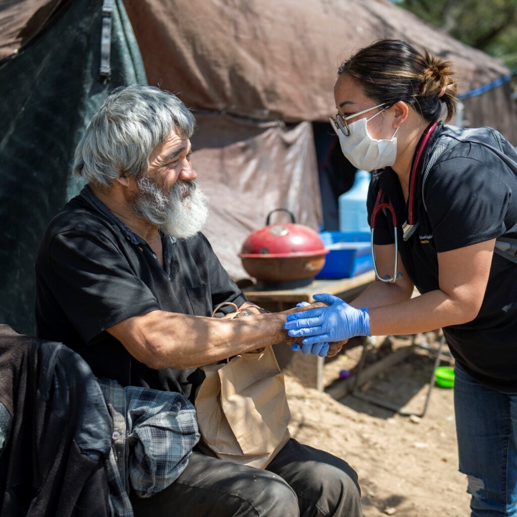 Dr. Joanne Suh says good-bye to Jorge Lopez after he enrolled in medical services during the outreach team wellness check with clients along Arroyo Seco in South Pasadena, April 21, 2020. The Union Station Multidisciplinary Team wanted to connect Jorge Lopez with medical services, and he finally accepted during this visit. (Photo Credit: Los Angeles County)