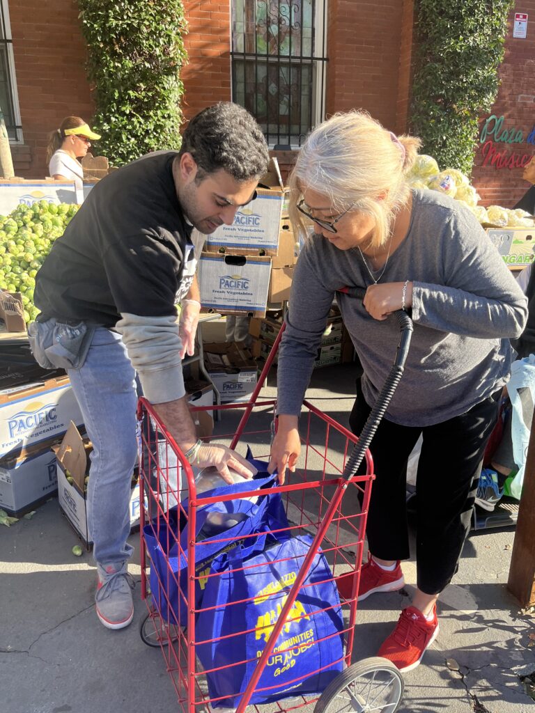 man helping lady with donations