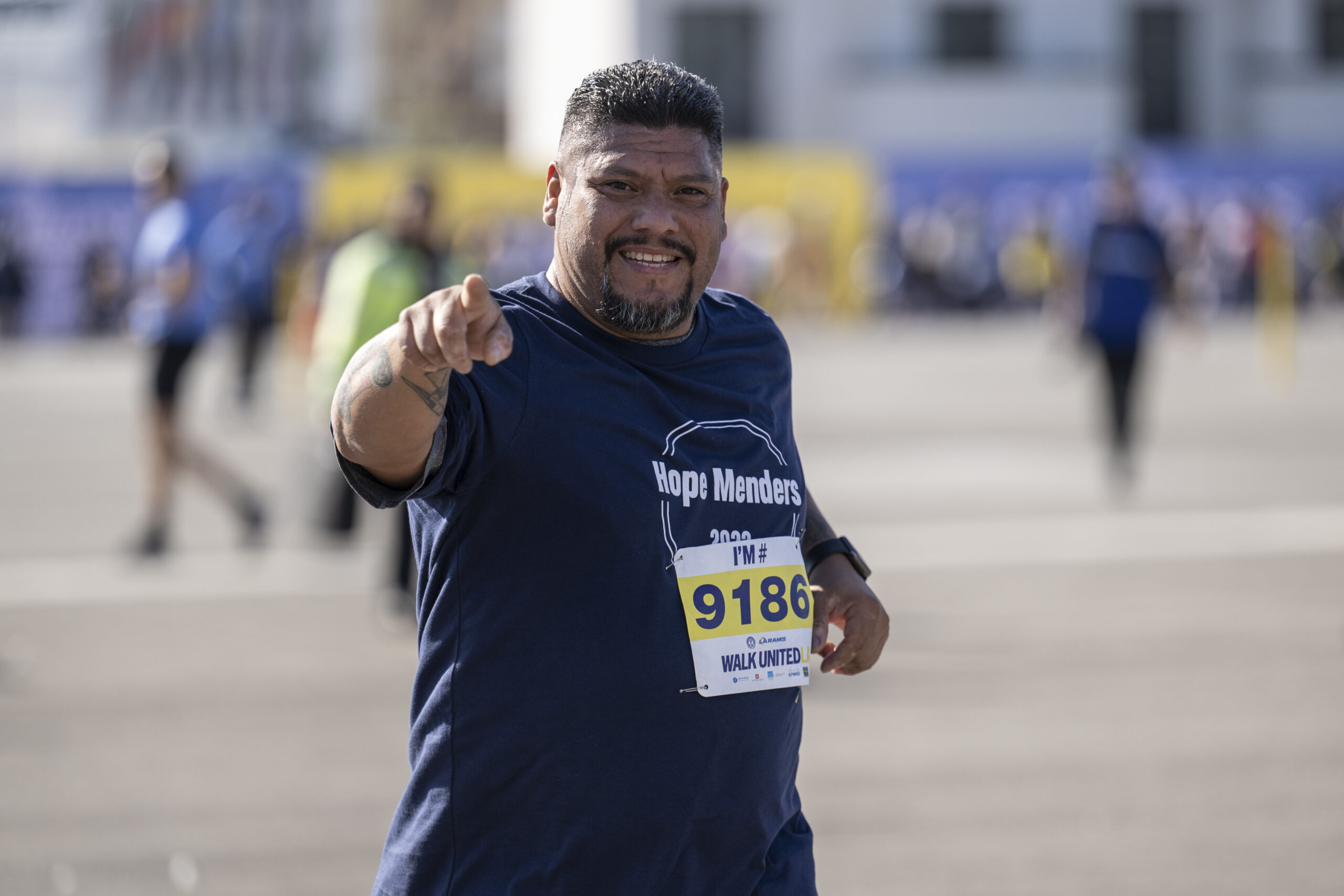 man running at pointing at camera