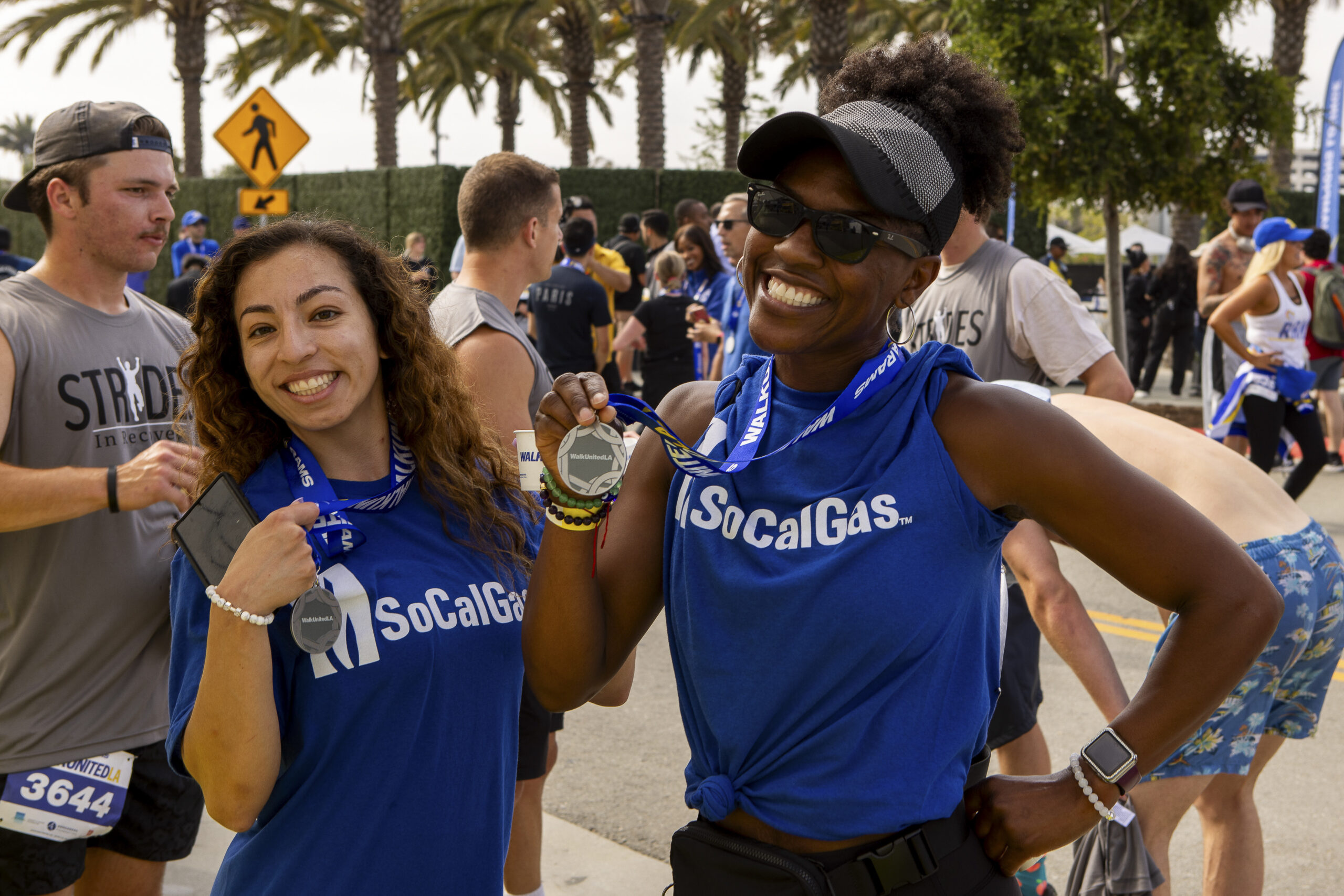 two women posing with medals