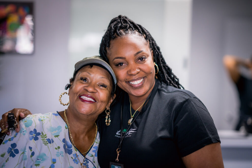 two women smiling at camera