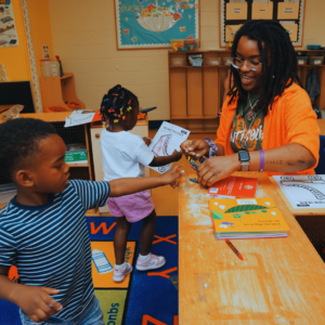 teacher helping young student
