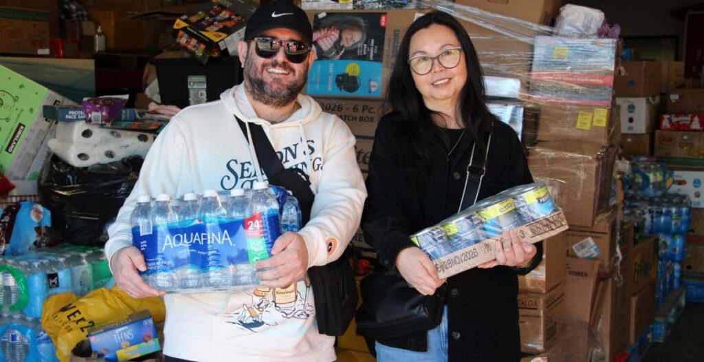 photo of man and woman carrying packaged goods