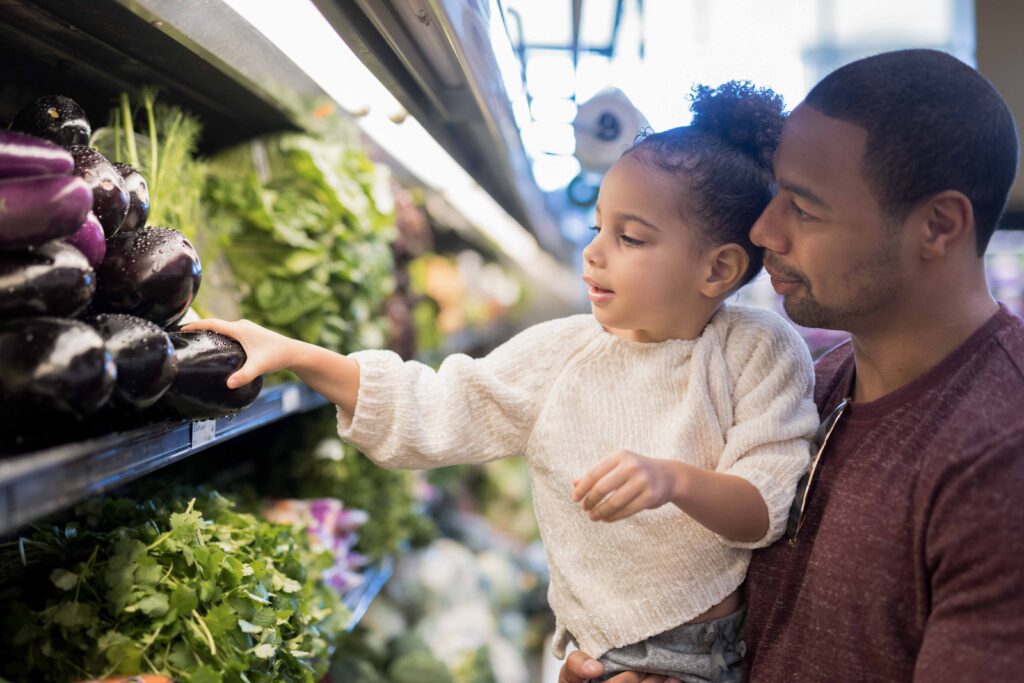 father and daughter grabbing groceries