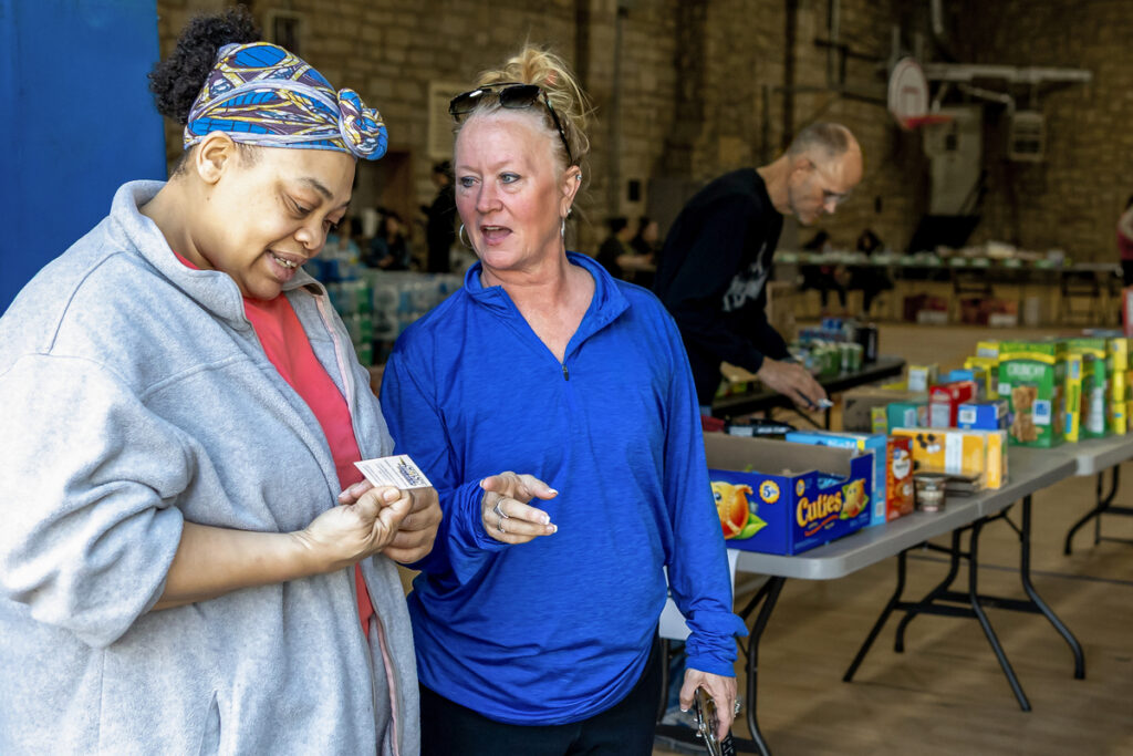 two women talking at a food bank